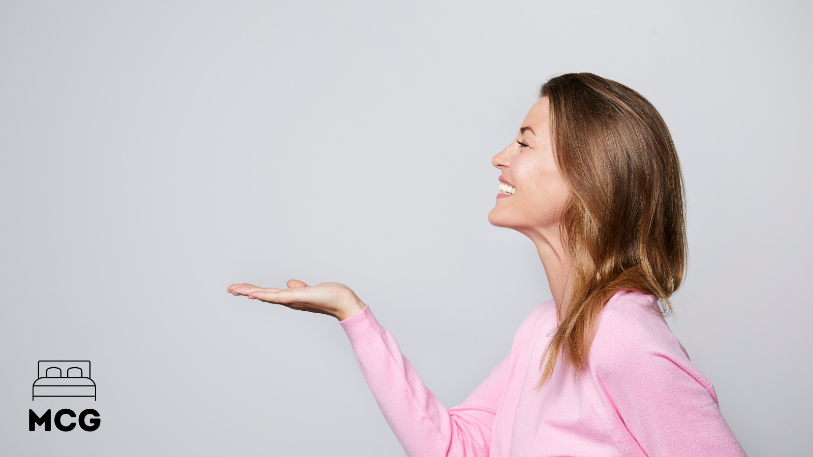 woman smiling and gesturing with hand