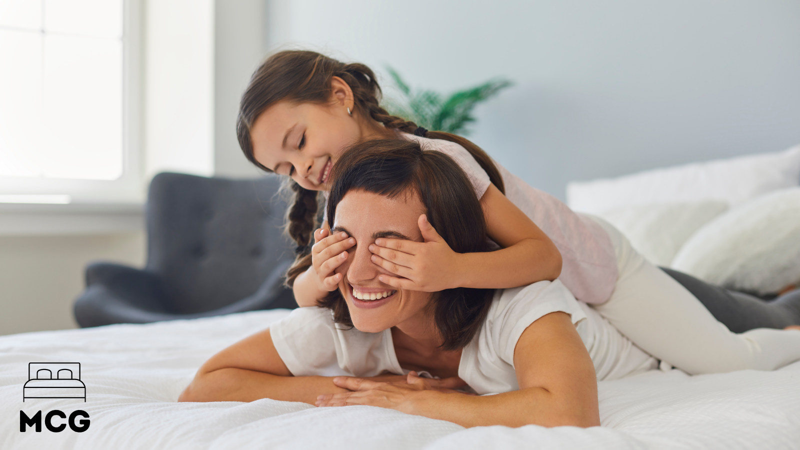 mother and daughter on a clean mattress