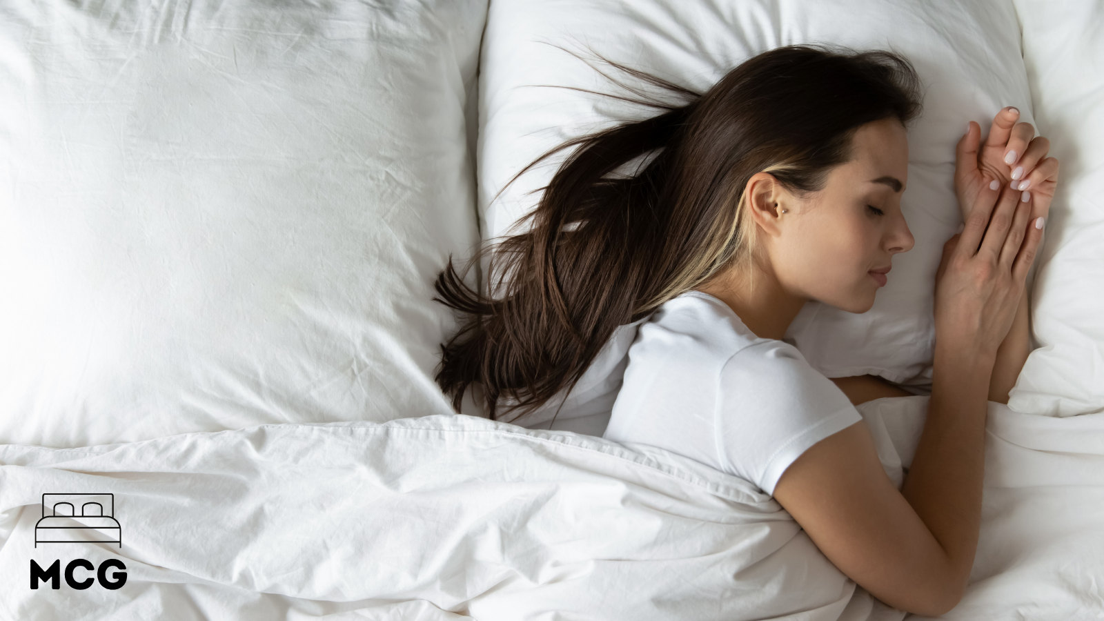 young woman sleeping on her side in bed