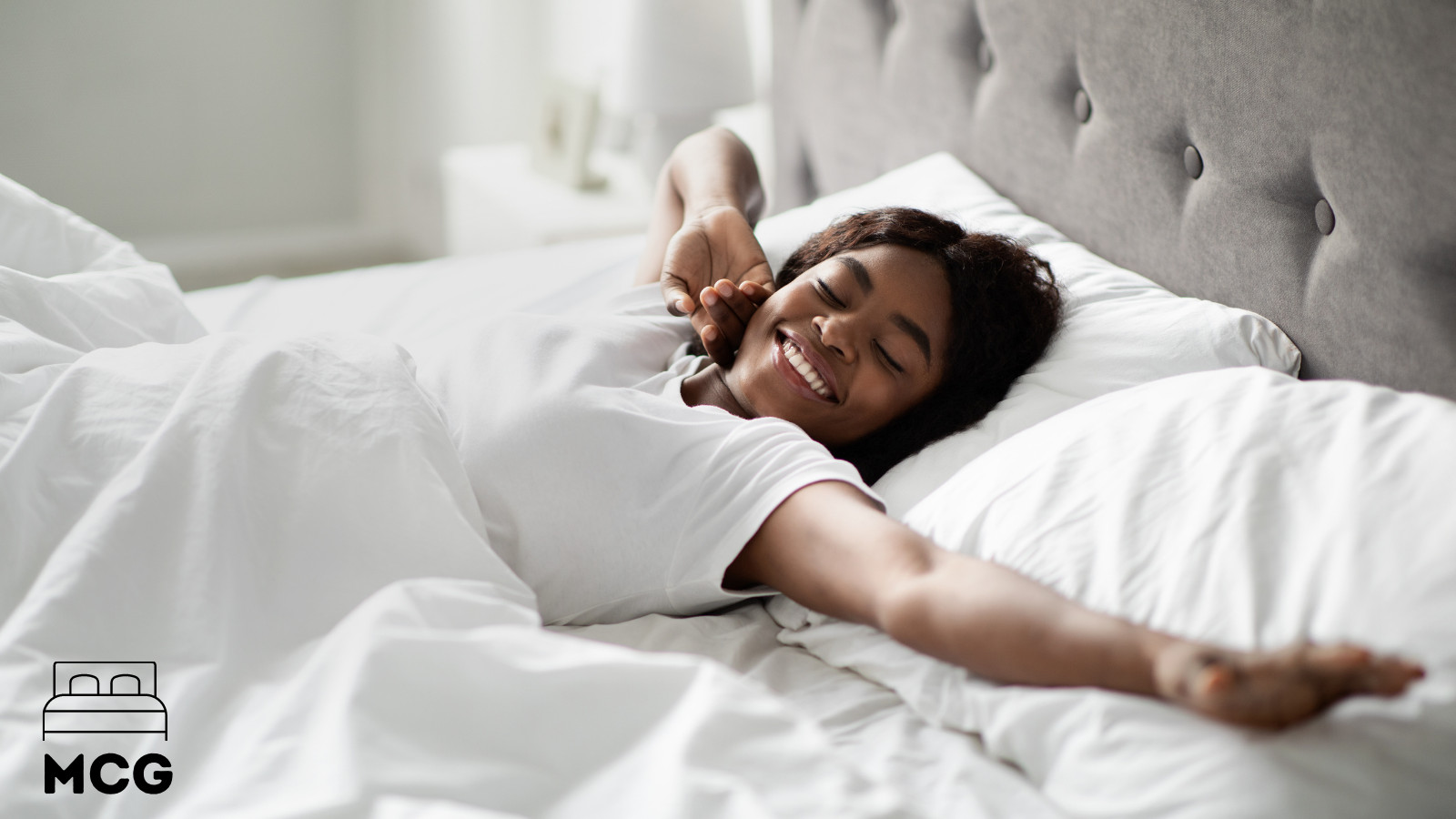 woman waking up on a white bed