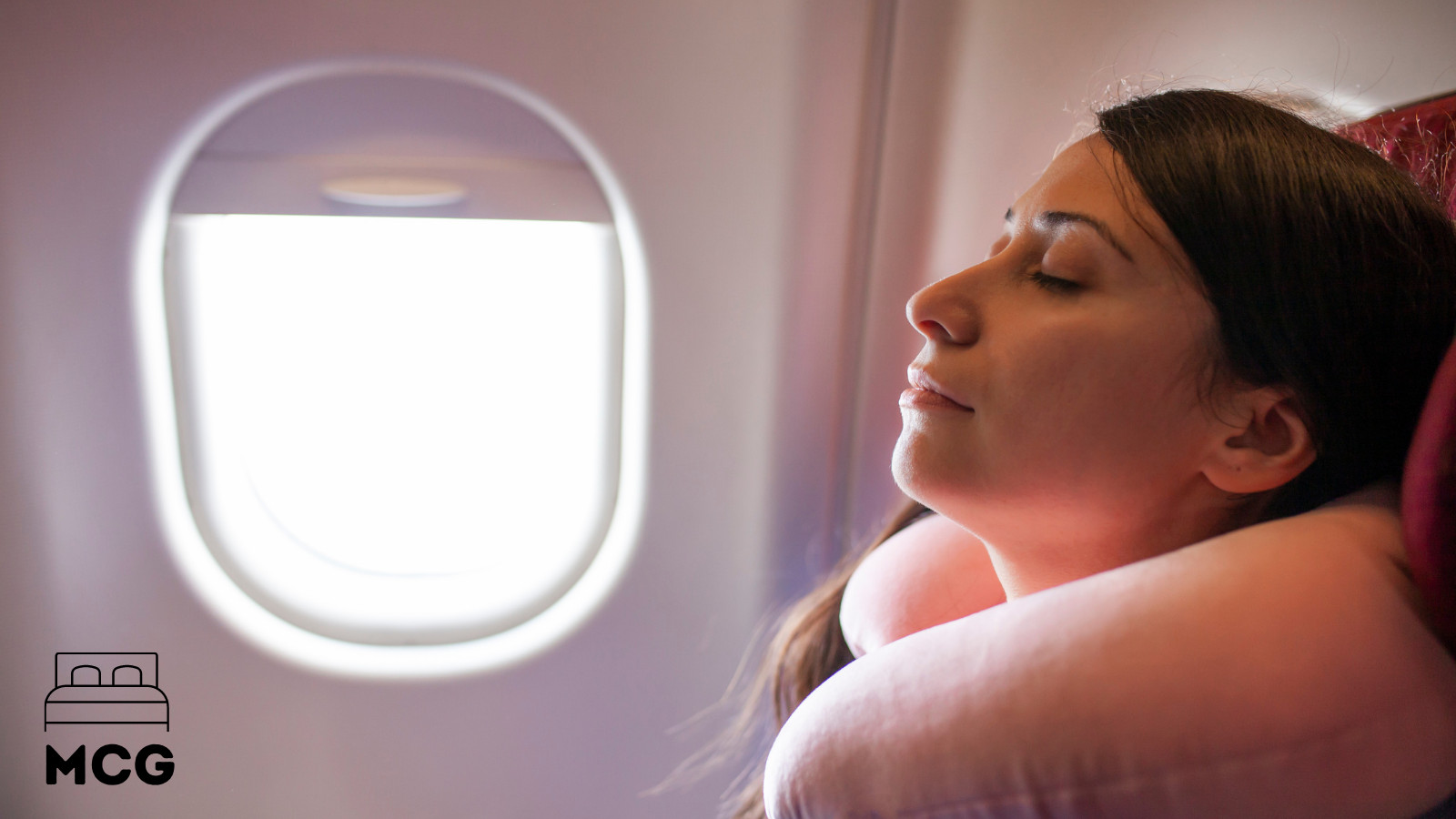lady sleeping on a plane with a neck pillow