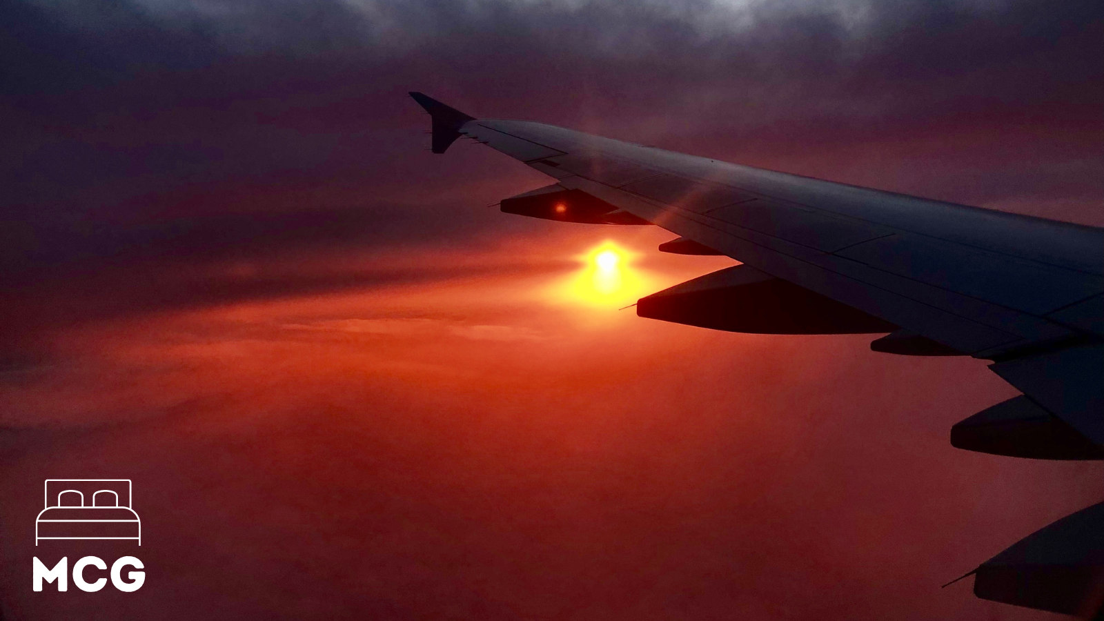 plane flying in the sky and sun setting in background