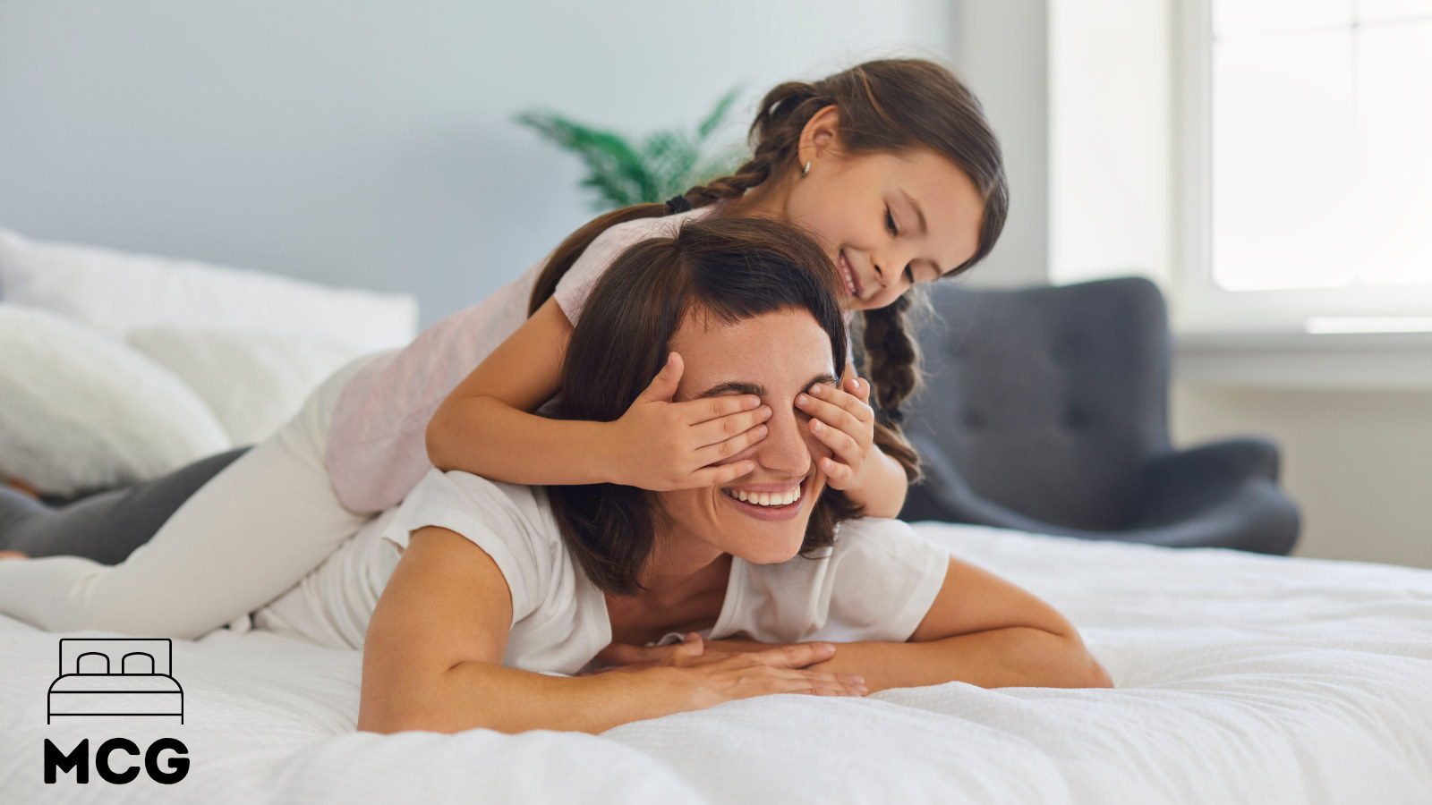 mother and daughter on a mattress topper