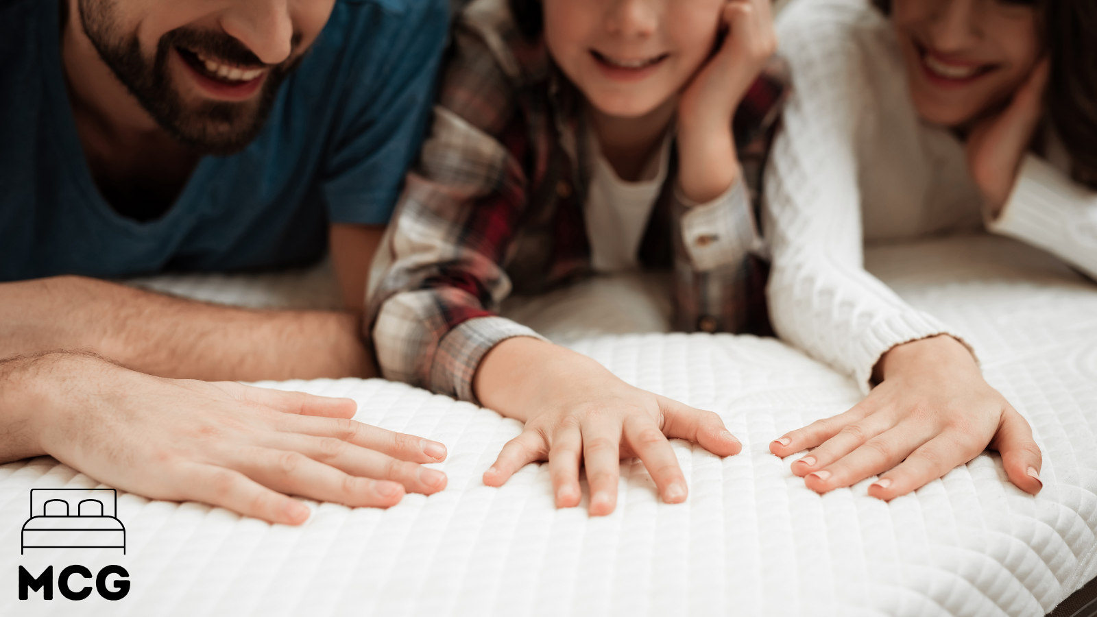 people laying hands on a hybrid mattress