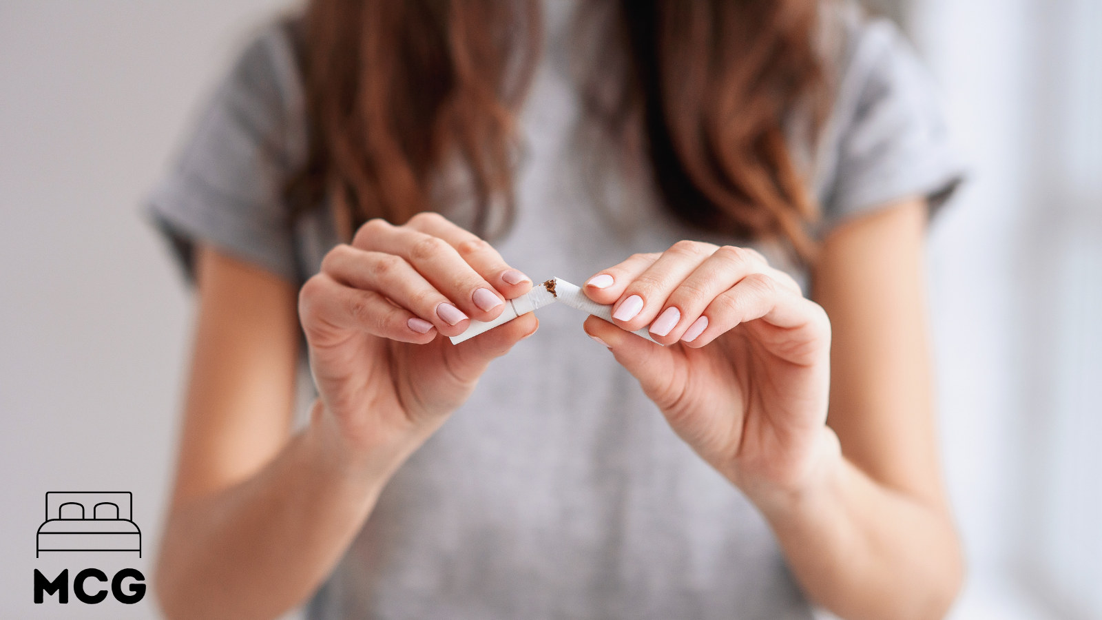 woman holding and breaking a cigarette