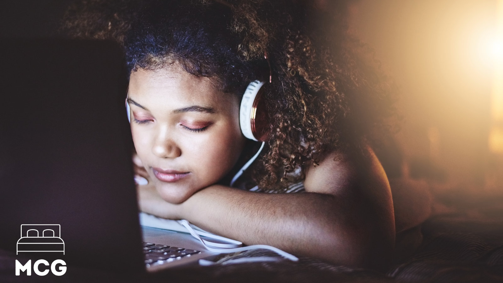 woman looking at a laptop screen and falling asleep