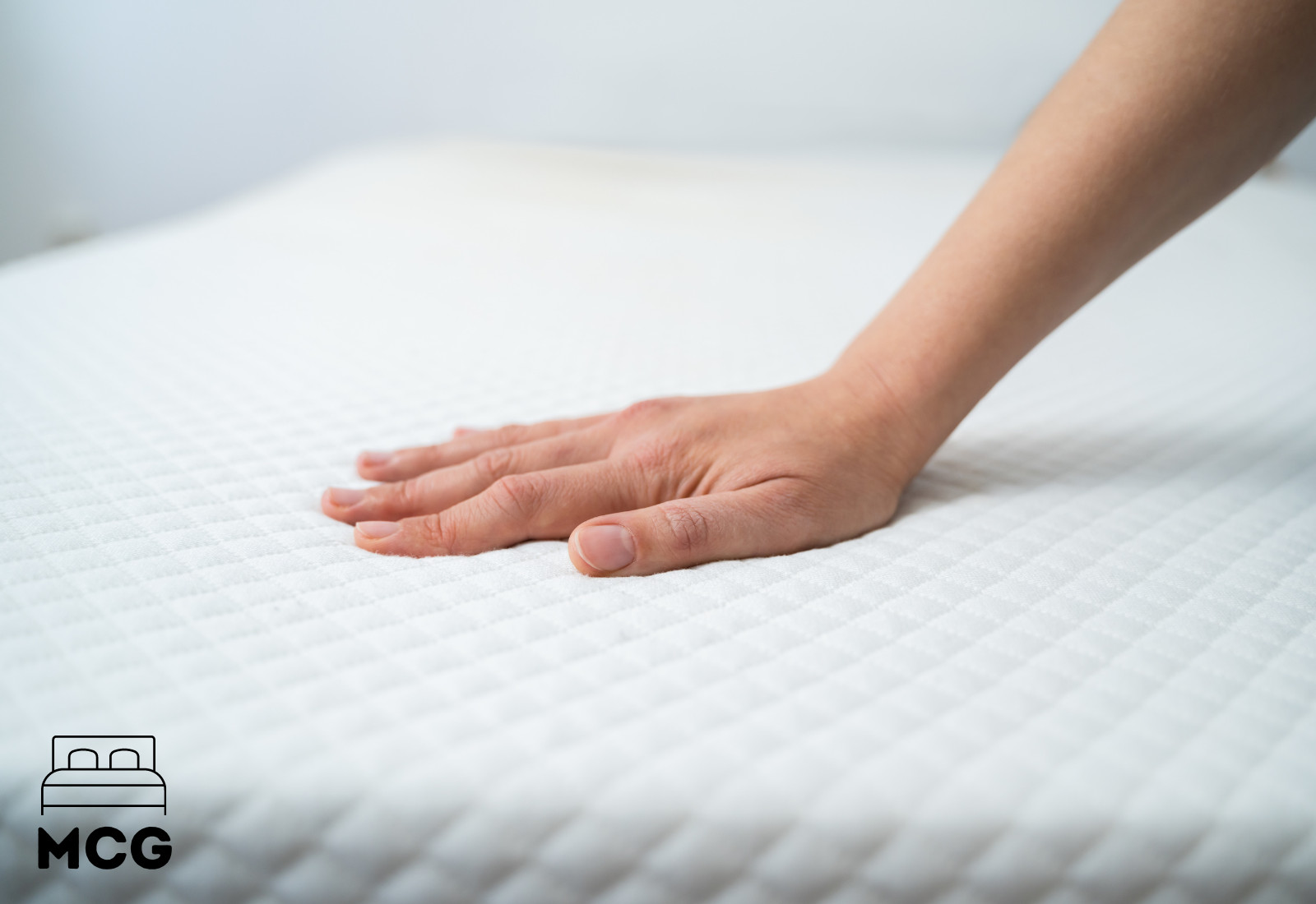 picture of a hand on a mattress protector