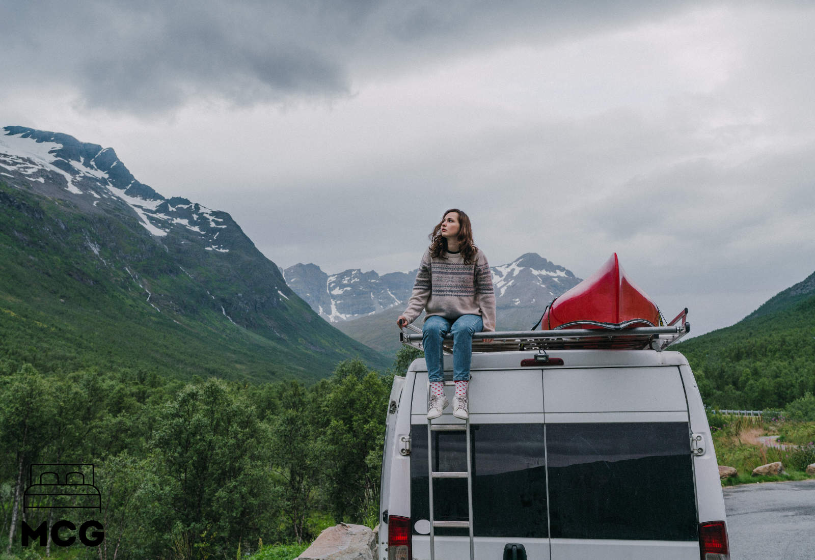 woman sitting on top of a motorhome