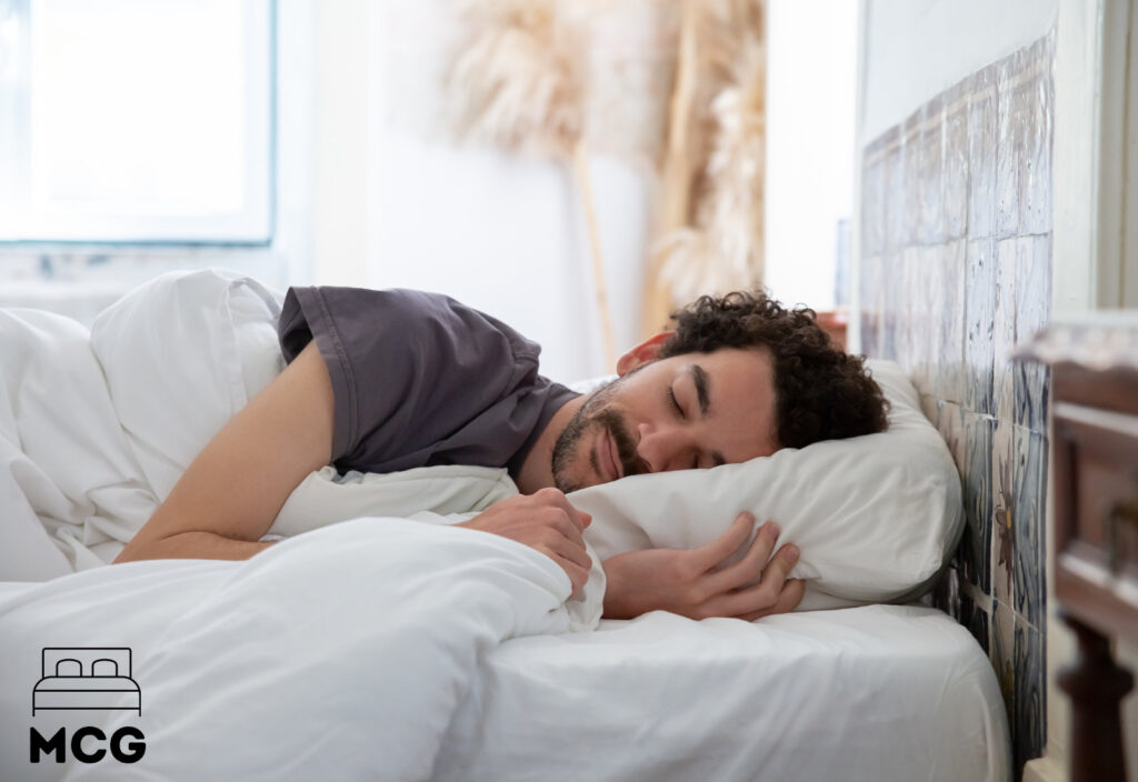 man asleep in a bed