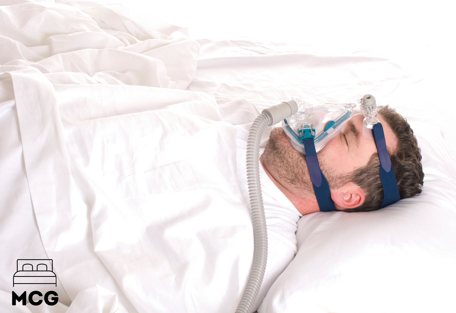 man sleeping in bed with sleep apnea