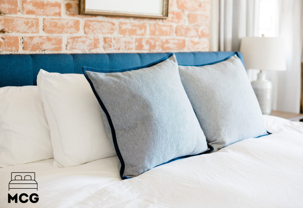 a blue bed headboard with cushions