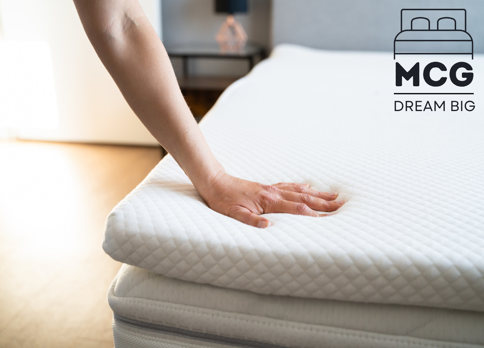 hand pressing on mattress surface
