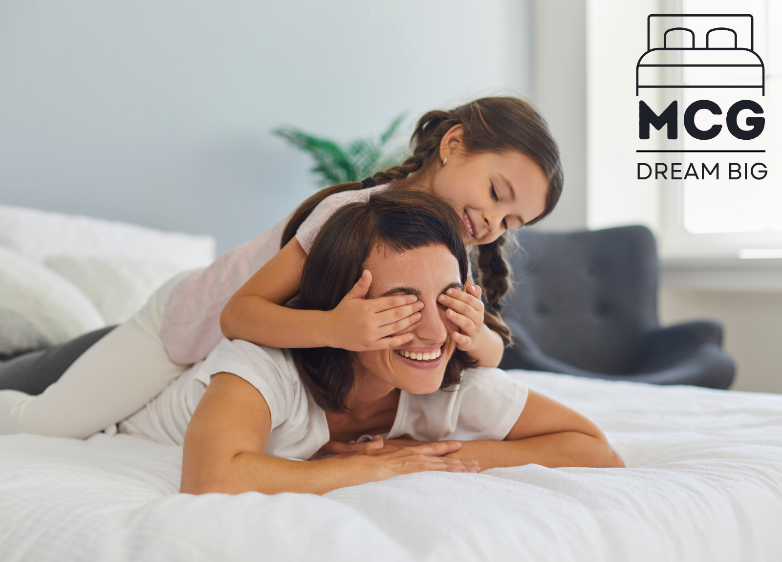 mother and daughter on comfortable mattress